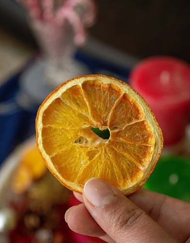 food selective focus photography of person holding sliced and dried fruit fruit